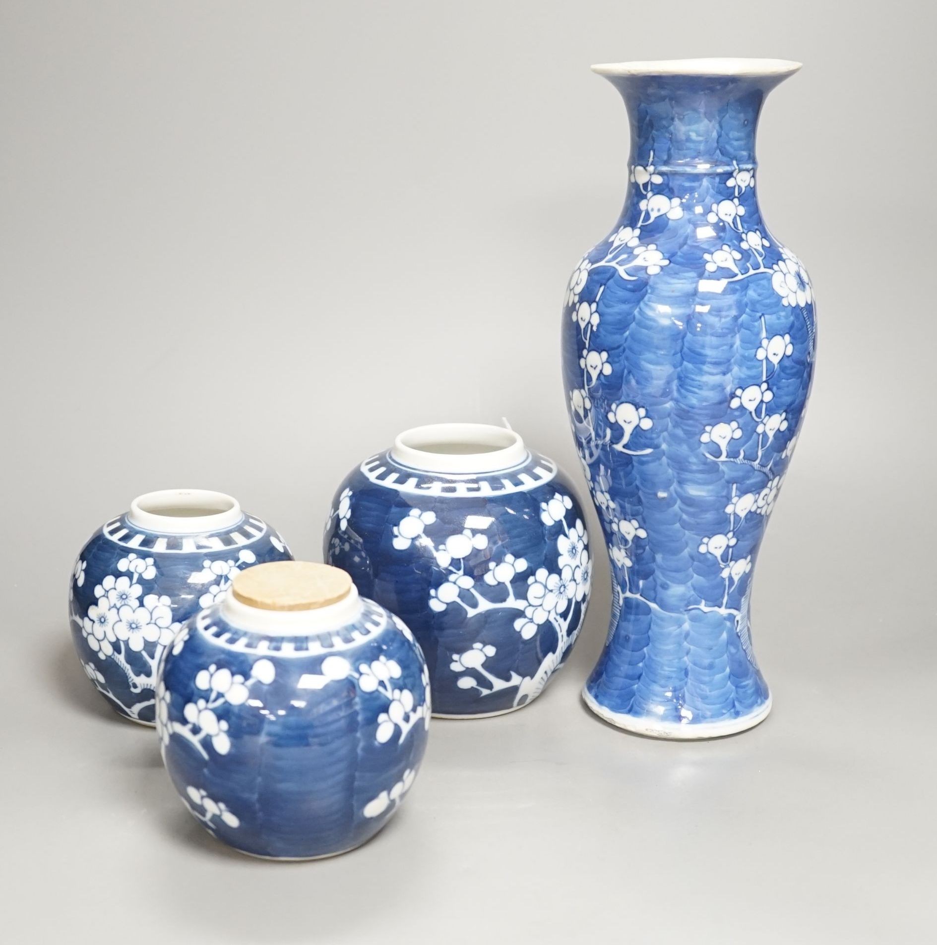 A Chinese blue and white prunus vase together with three similar jars. Vase height 30cm